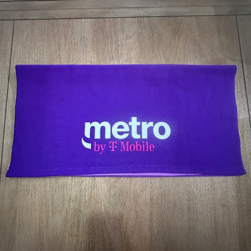 T-Mobile Tuesdays Towel in purple, pink, and white 100% polyester